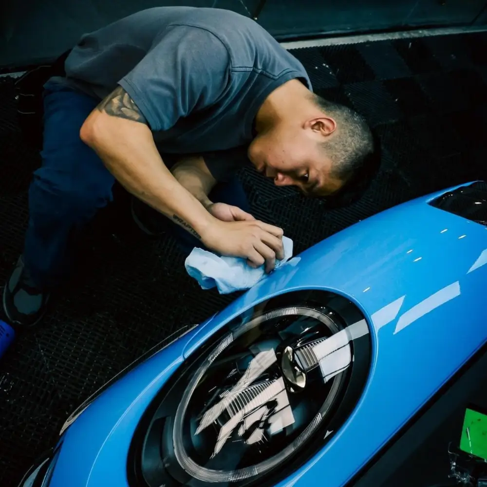 rex applying ceramic coating on blue vehicle